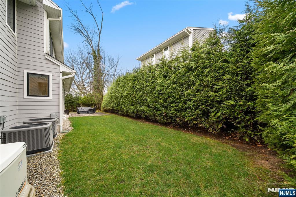 55 Cedar Street Cresskill, NJ 07626 - Photo 38 of 40 a view of a backyard with potted plants and wooden fence