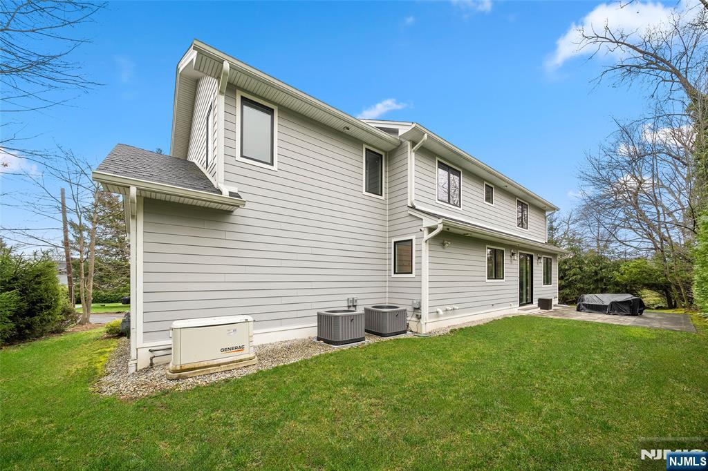 55 Cedar Street Cresskill, NJ 07626 - Photo 39 of 40 a front view of a house with a garden