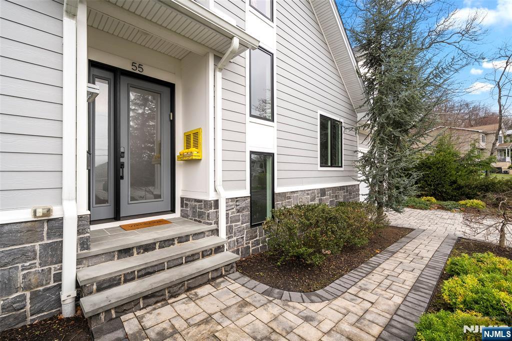 55 Cedar Street Cresskill, NJ 07626 - Photo 4 of 40 a front view of a house with a garden