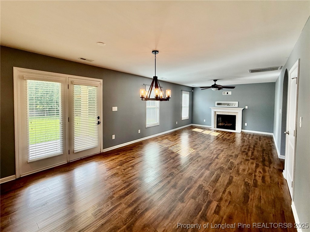 512 Townsend Road Raeford, NC 28376 - Photo 11 of 20 a big room with wooden floor fireplace and windows