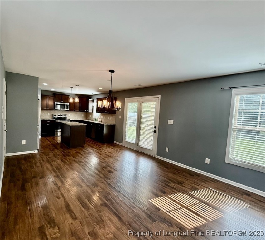 512 Townsend Road Raeford, NC 28376 - Photo 8 of 20 a large kitchen with kitchen island a sink dishwasher a stove and a refrigerator with wooden floor