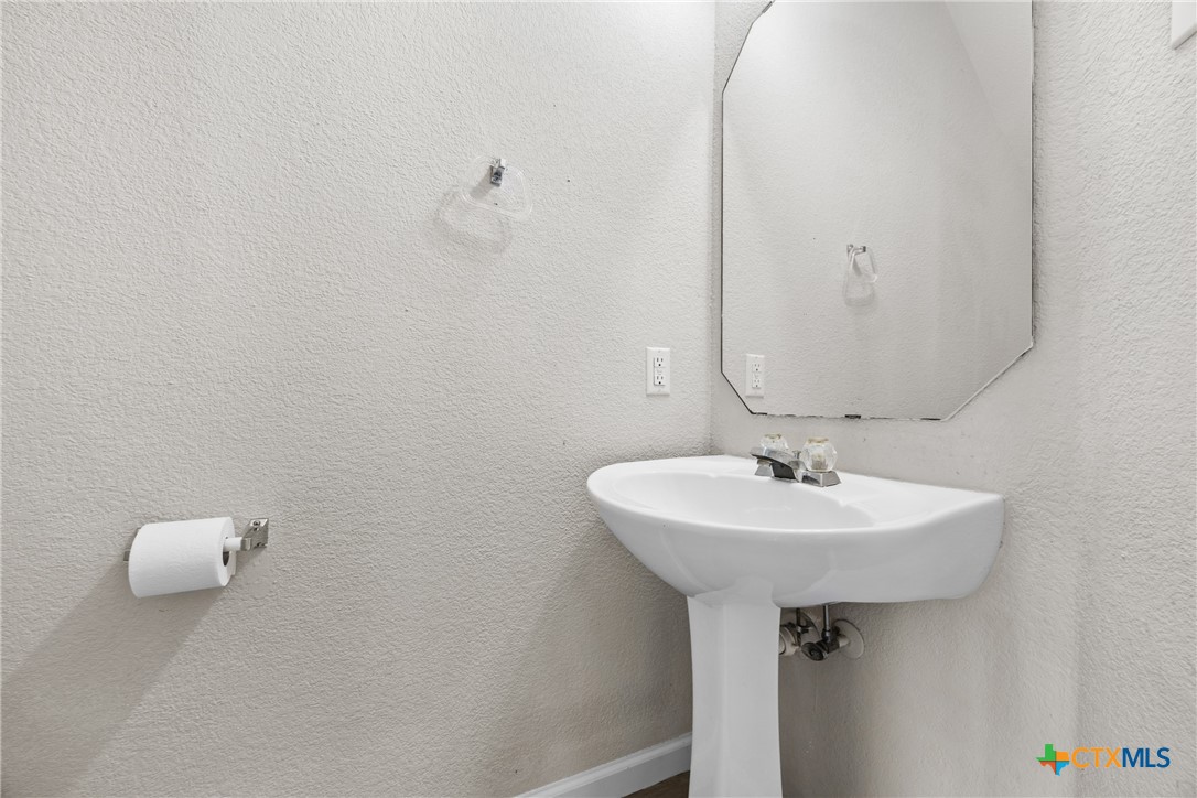 2117 Schwald Road Killeen, TX 76543 - Photo 13 of 29 a bathroom with a sink a mirror and vanity