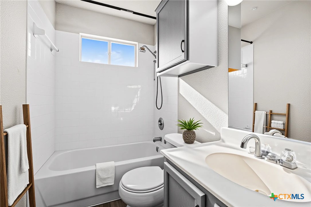 2117 Schwald Road Killeen, TX 76543 - Photo 19 of 29 a bathroom with a granite countertop sink a toilet and shower