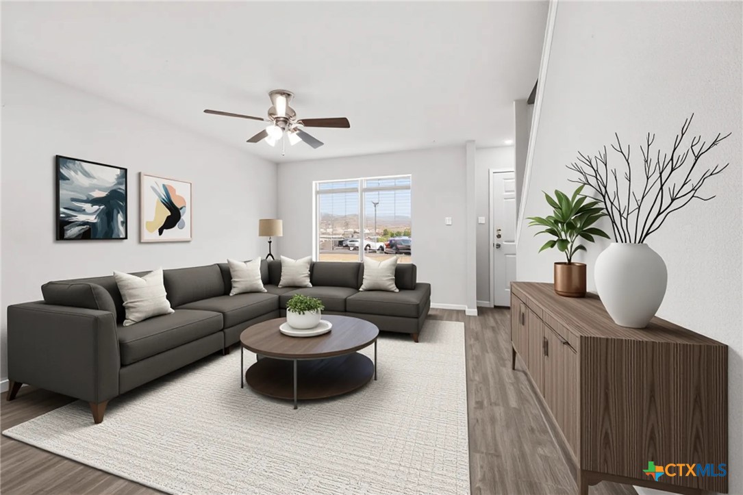 2117 Schwald Road Killeen, TX 76543 - Photo 3 of 29 a living room with furniture a chandelier and a potted plant