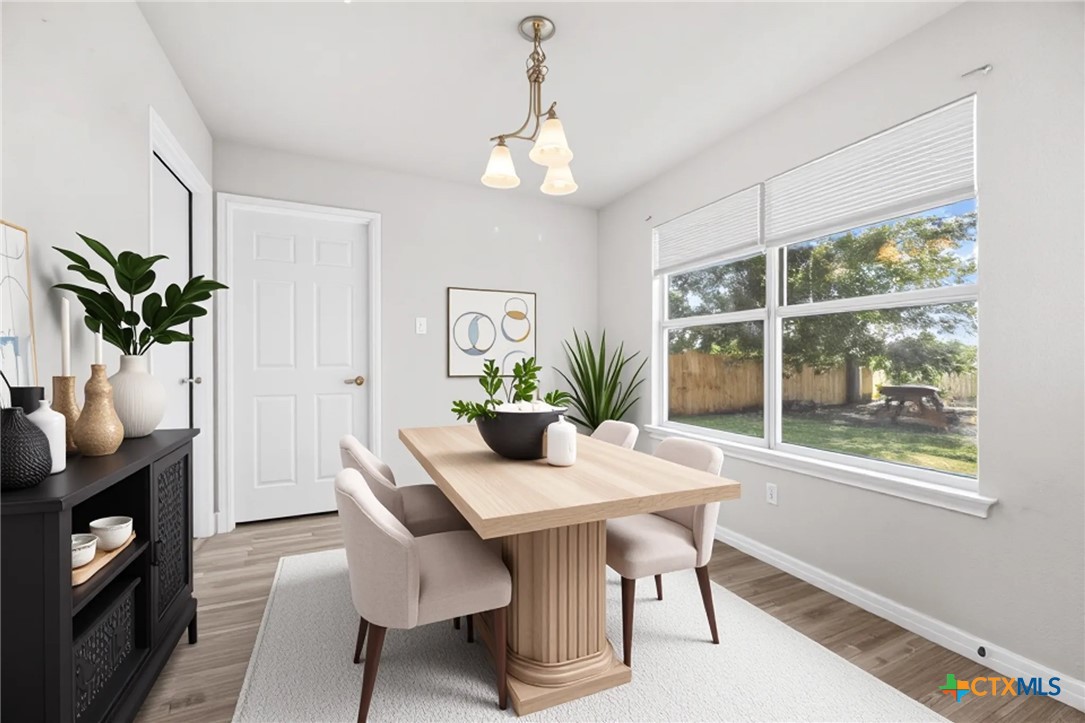 2117 Schwald Road Killeen, TX 76543 - Photo 7 of 29 a dining room with furniture potted plants and wooden floor