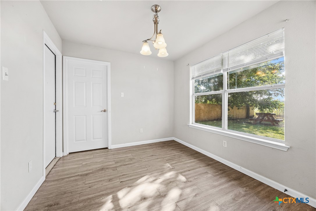 2117 Schwald Road Killeen, TX 76543 - Photo 8 of 29 an empty room with wooden floor and windows