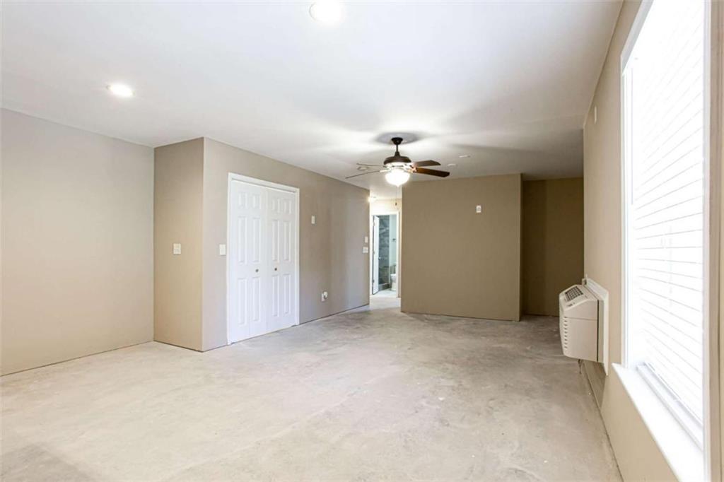 3721 Bogan Mill Road Northeast Buford, GA 30519 - Photo 40 of 58 an empty room with a chandelier fan and glass door