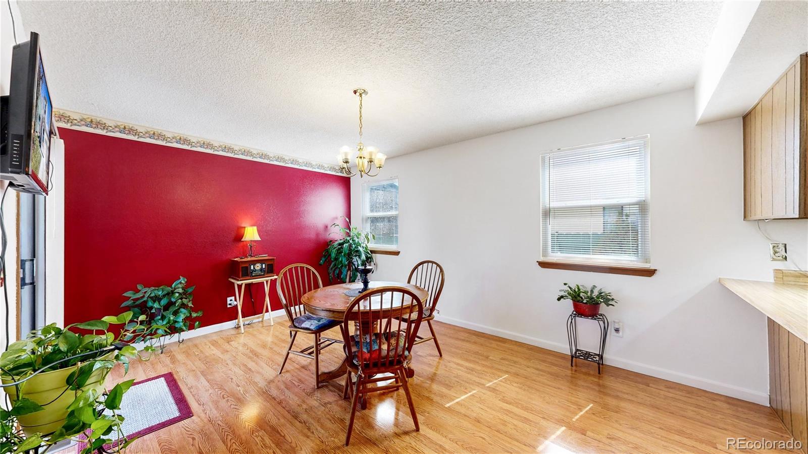 8906 Everett Street Broomfield, CO 80021 - Photo 11 of 35 a view of a dining room with furniture and chandelier
