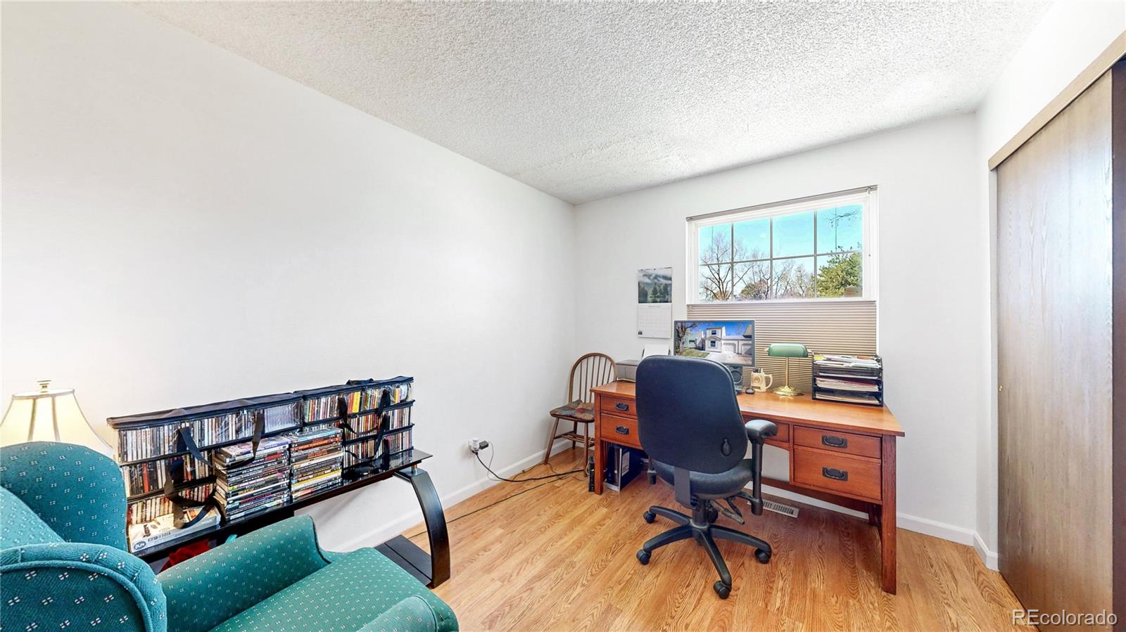 8906 Everett Street Broomfield, CO 80021 - Photo 13 of 35 a view of a workspace with furniture and a window