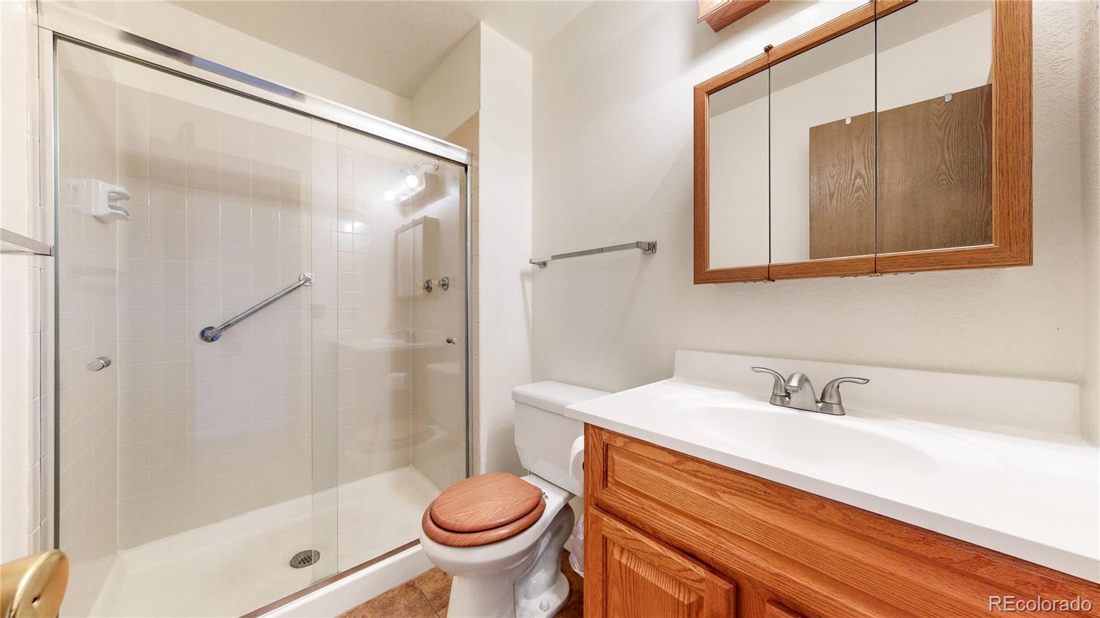 8906 Everett Street Broomfield, CO 80021 - Photo 18 of 35 a bathroom with a sink and a mirror