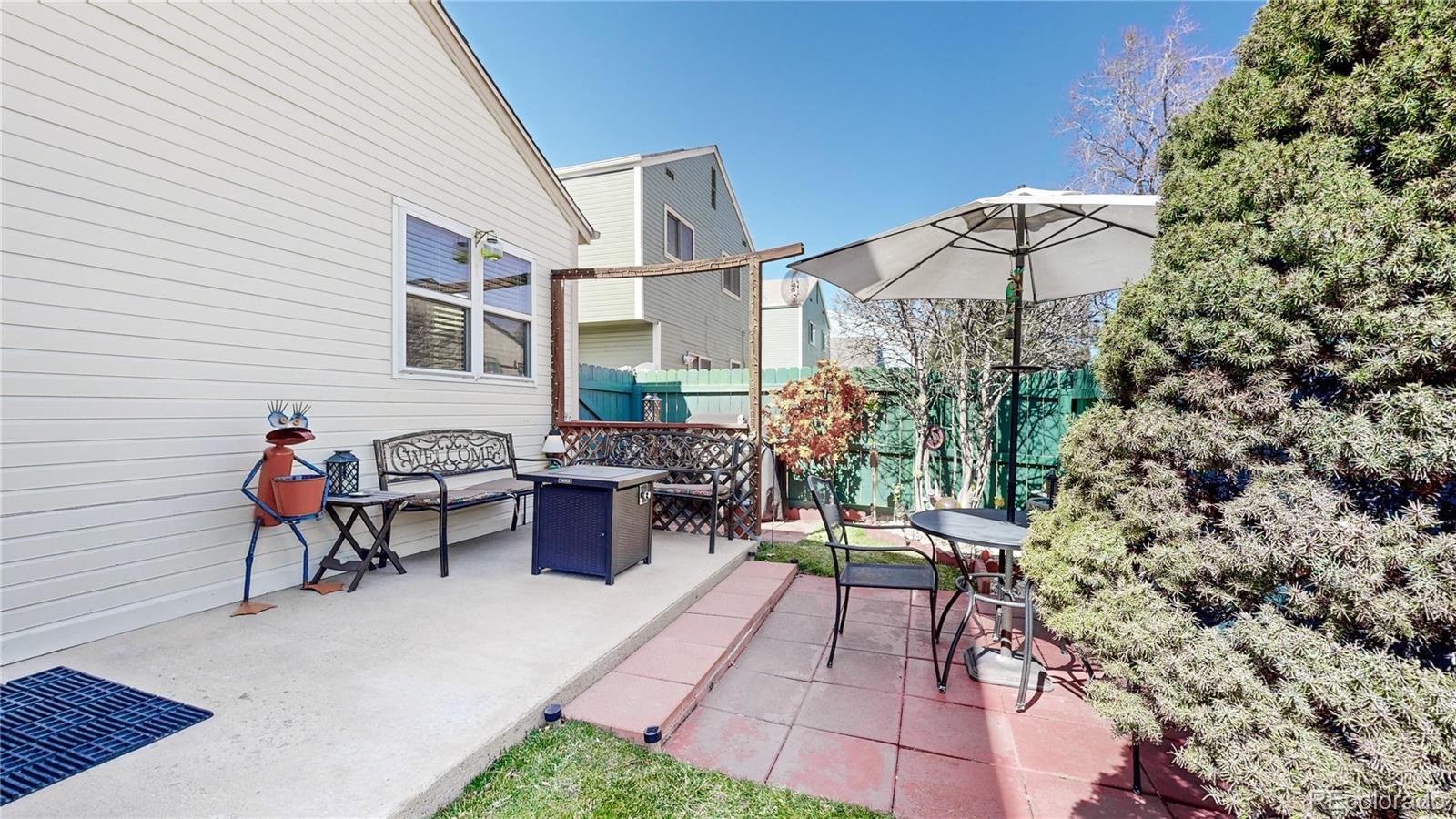 8906 Everett Street Broomfield, CO 80021 - Photo 23 of 35 a backyard of a house with table and chairs