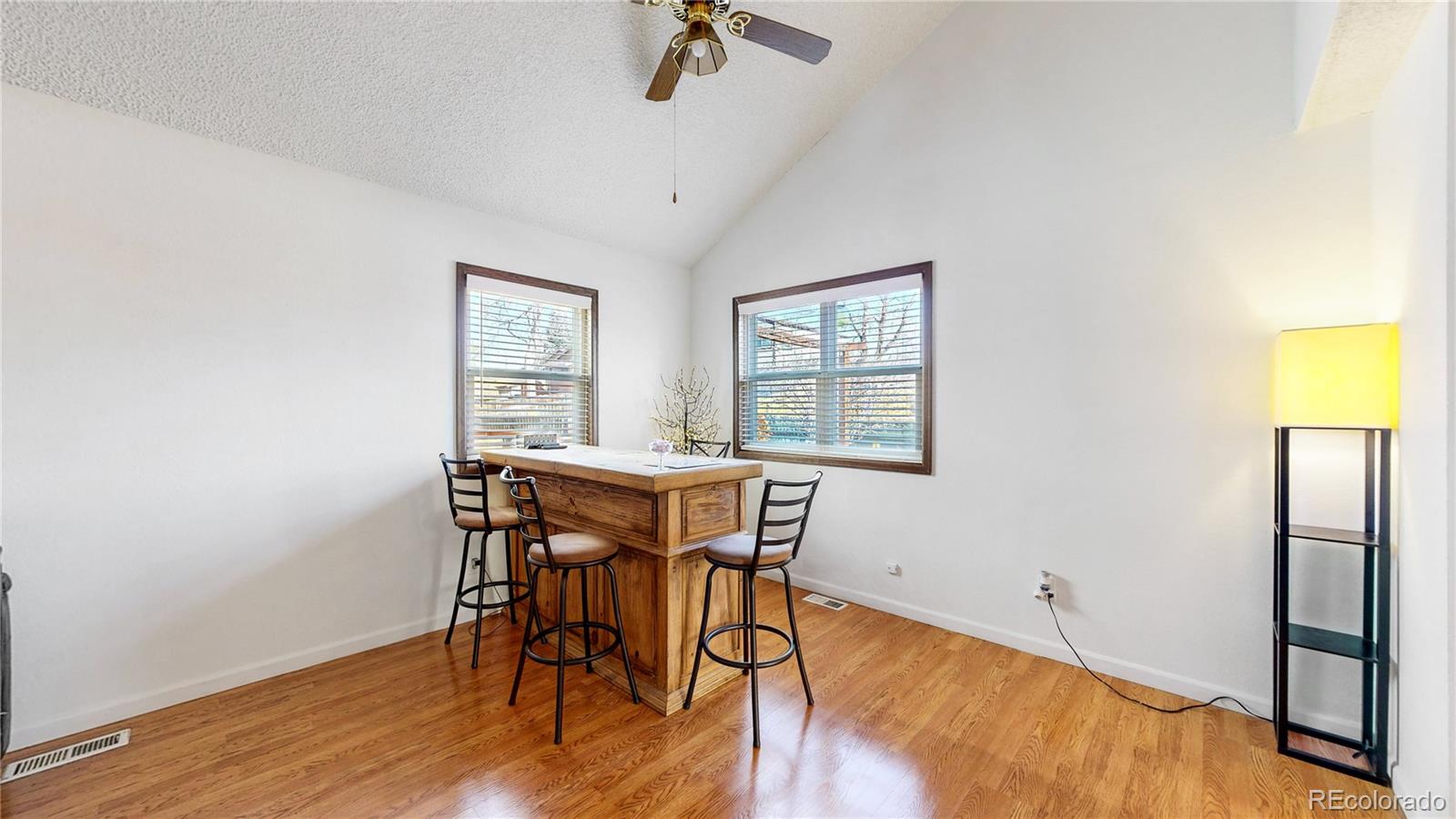 8906 Everett Street Broomfield, CO 80021 - Photo 5 of 35 a view of a dining room with furniture window and wooden floor