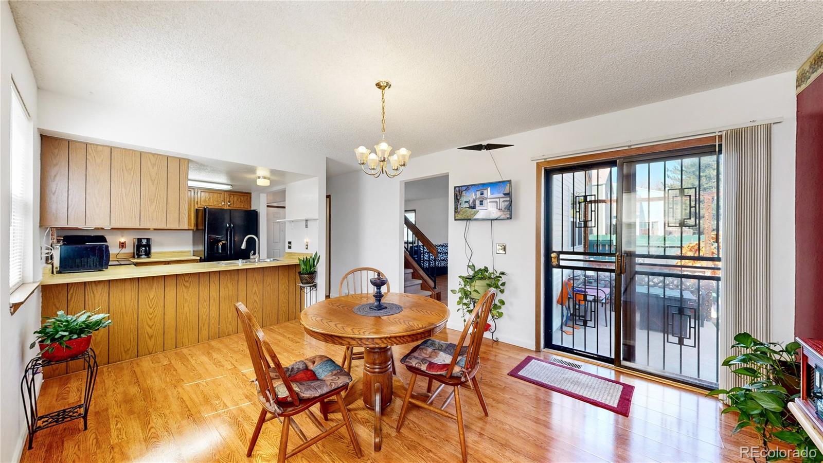 8906 Everett Street Broomfield, CO 80021 - Photo 6 of 35 a view of a dining room with furniture window and wooden floor