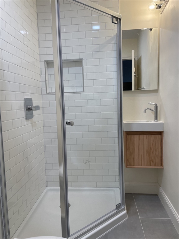 26-28 Adrian Street Somerville, MA 02143 - Photo 12 of 32 a bathroom with a shower and a sink