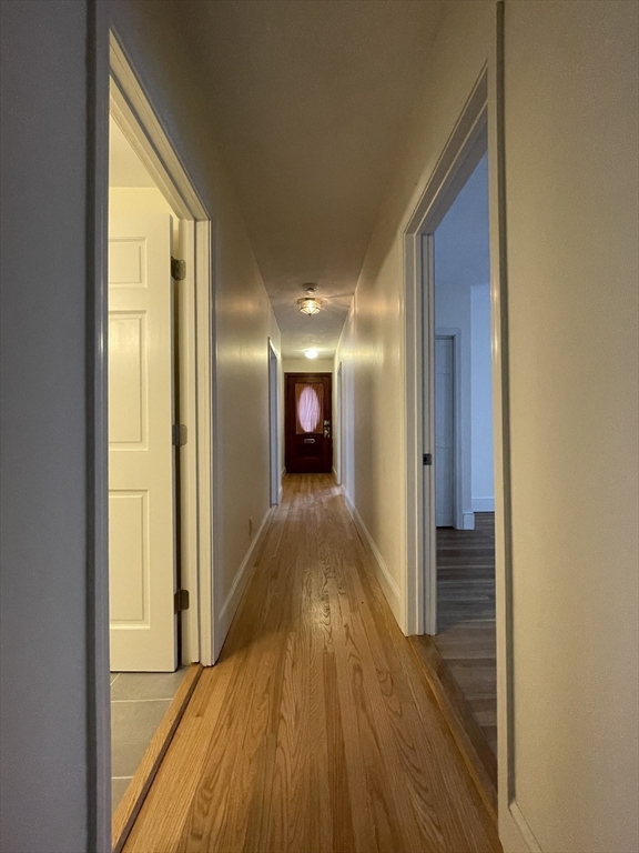 26-28 Adrian Street Somerville, MA 02143 - Photo 13 of 32 a view of hallway with wooden floor