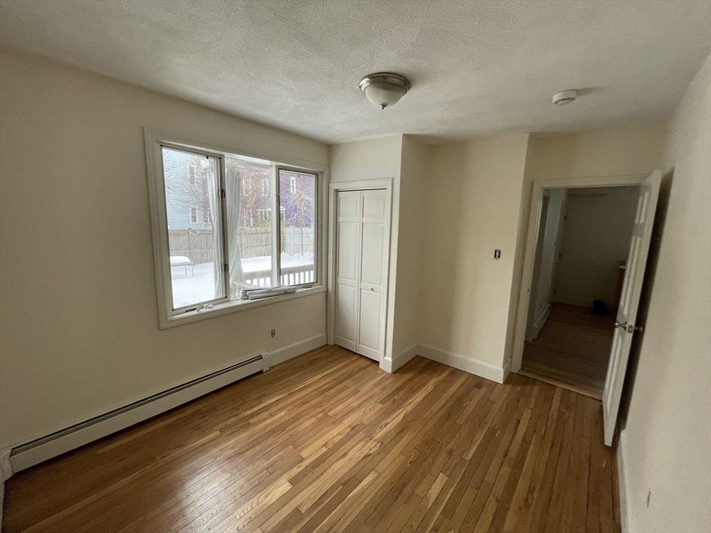 26-28 Adrian Street Somerville, MA 02143 - Photo 14 of 32 a view of a room with wooden floor and window