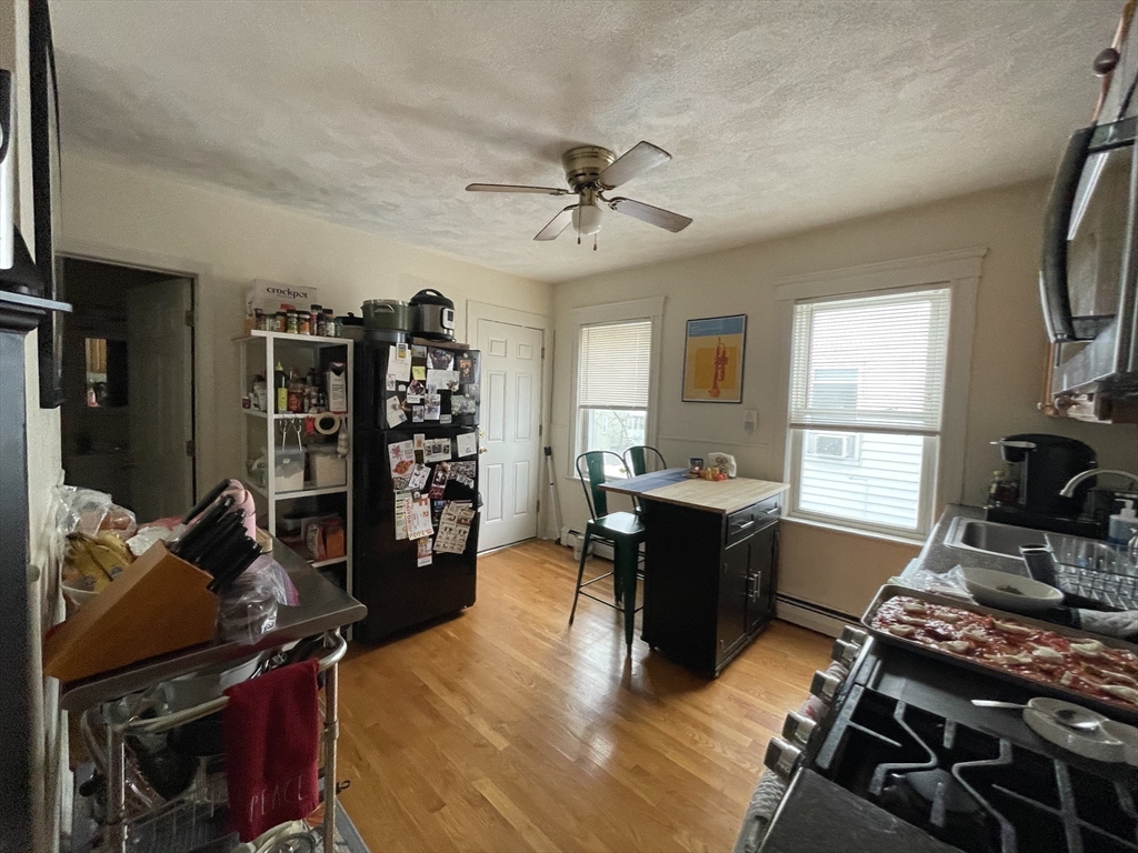 26-28 Adrian Street Somerville, MA 02143 - Photo 20 of 32 a room with furniture a chandelier and a window