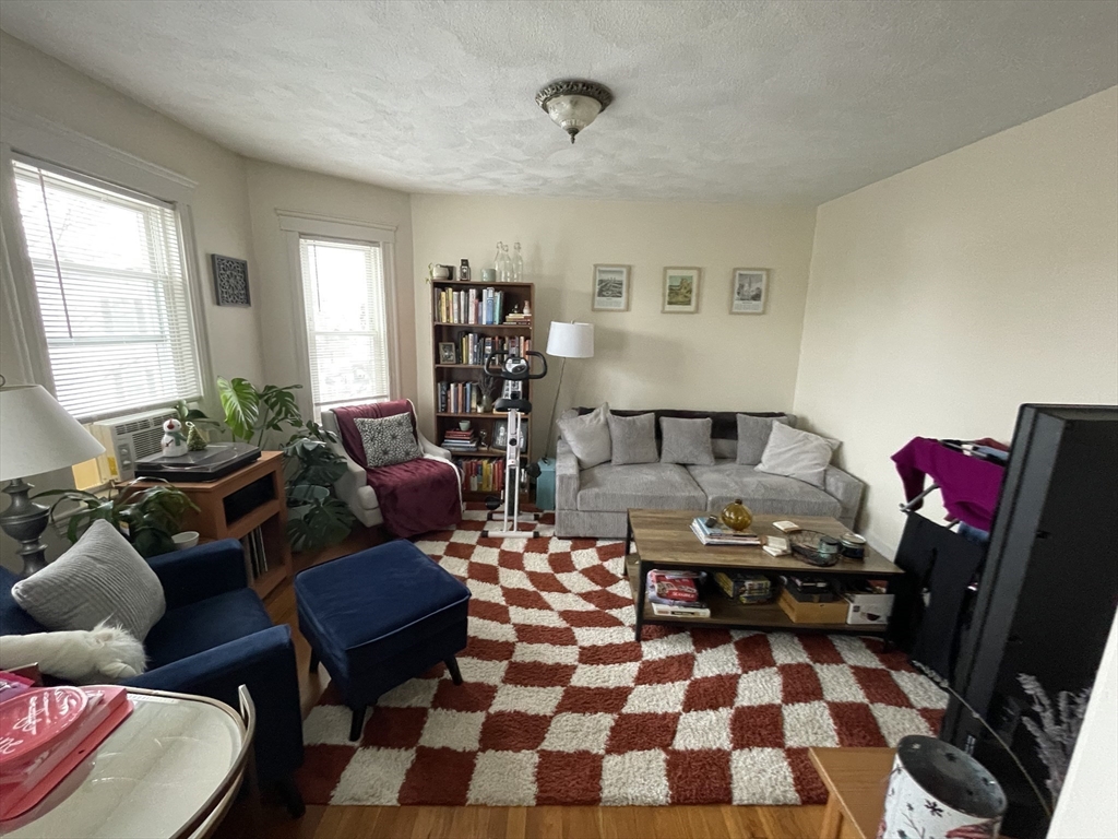 26-28 Adrian Street Somerville, MA 02143 - Photo 21 of 32 a living room with furniture and wooden floor