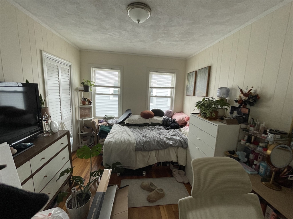 26-28 Adrian Street Somerville, MA 02143 - Photo 23 of 32 a bedroom with a bed and flat screen tv