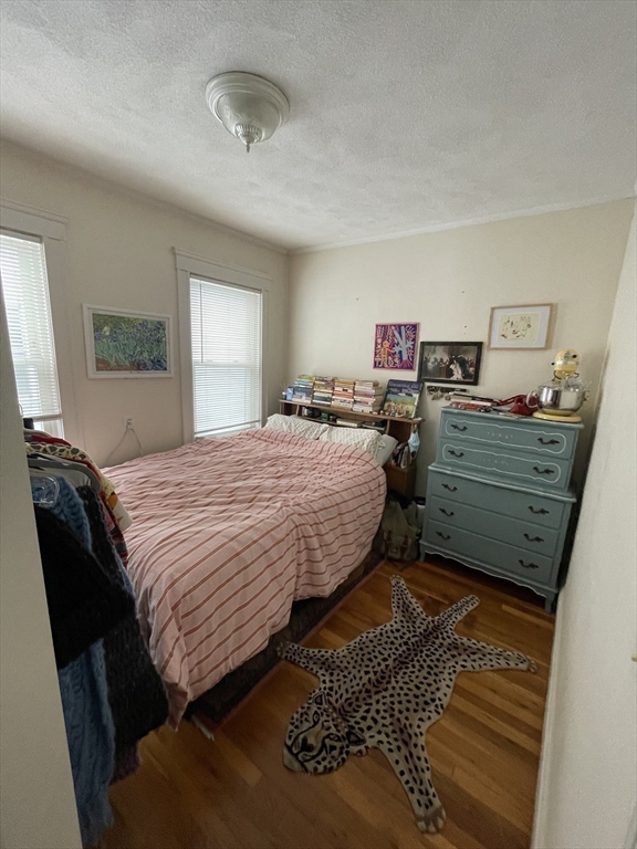 26-28 Adrian Street Somerville, MA 02143 - Photo 25 of 32 a bedroom with a bed and a dresser