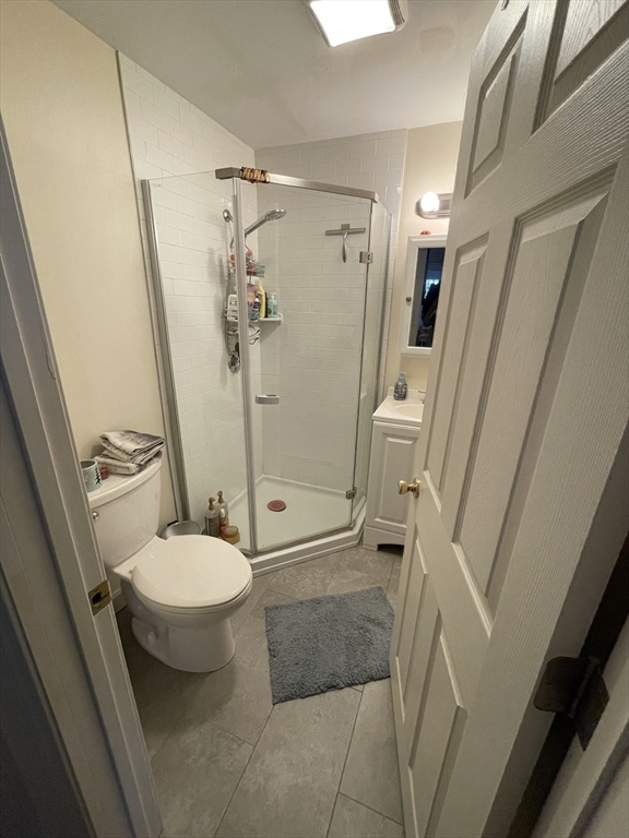 26-28 Adrian Street Somerville, MA 02143 - Photo 26 of 32 a bathroom with a granite countertop sink toilet and shower