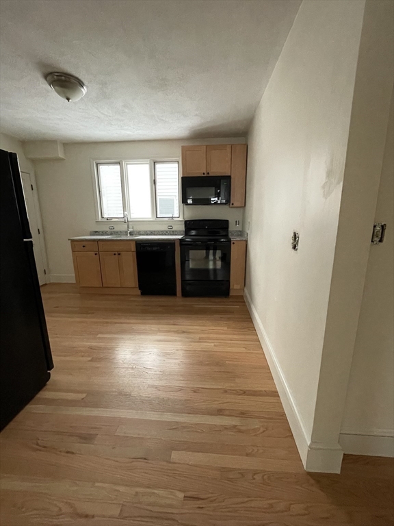 26-28 Adrian Street Somerville, MA 02143 - Photo 8 of 32 a living room with furniture and a wooden floor