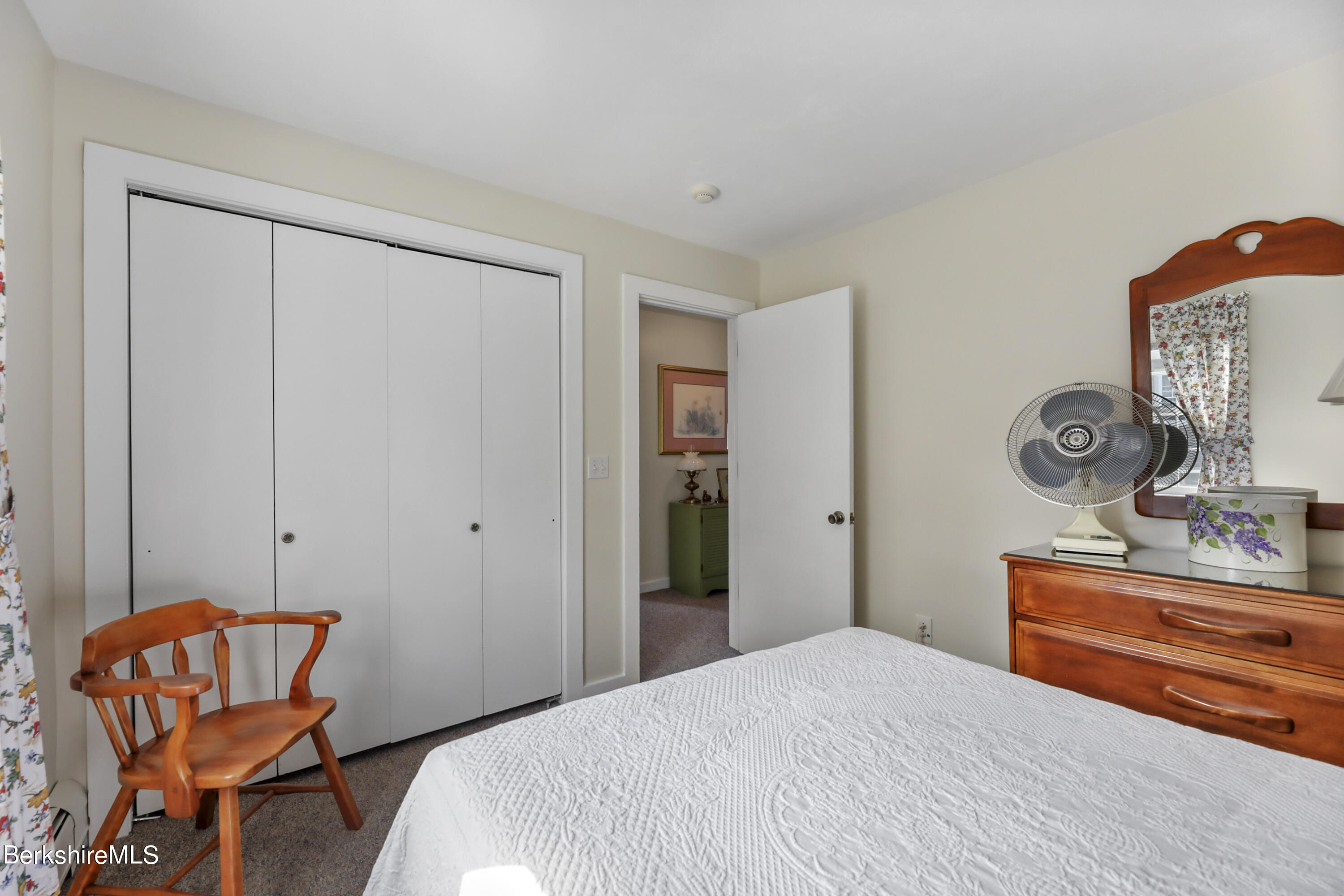 125 Center Street, Unit 2 Lee, MA 01238 - Photo 35 of 39 a bedroom with a bed and a chair in it