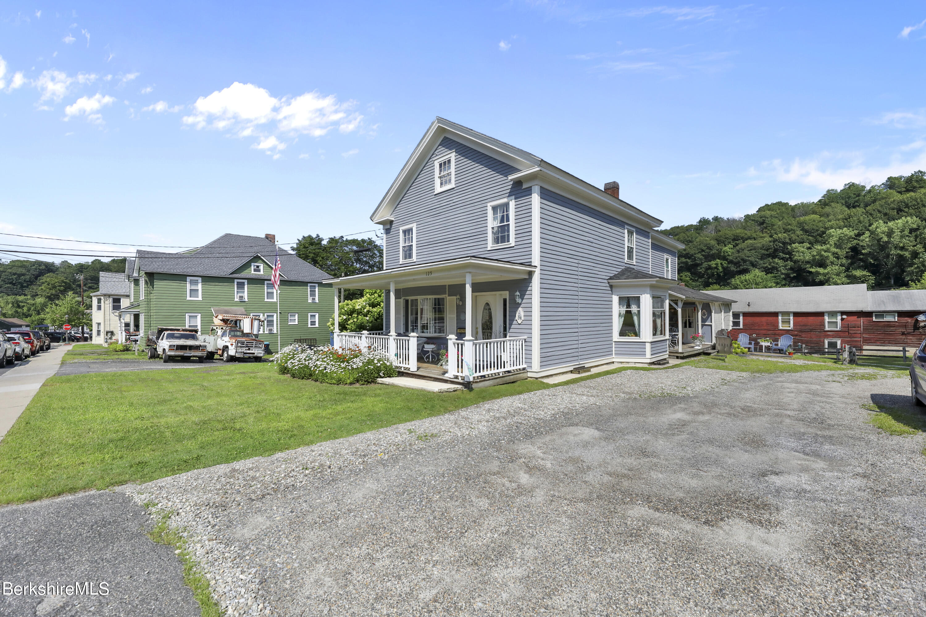 125 Center Street, Unit 2 Lee, MA 01238 - Photo 4 of 39 a front view of a house with a yard and garage