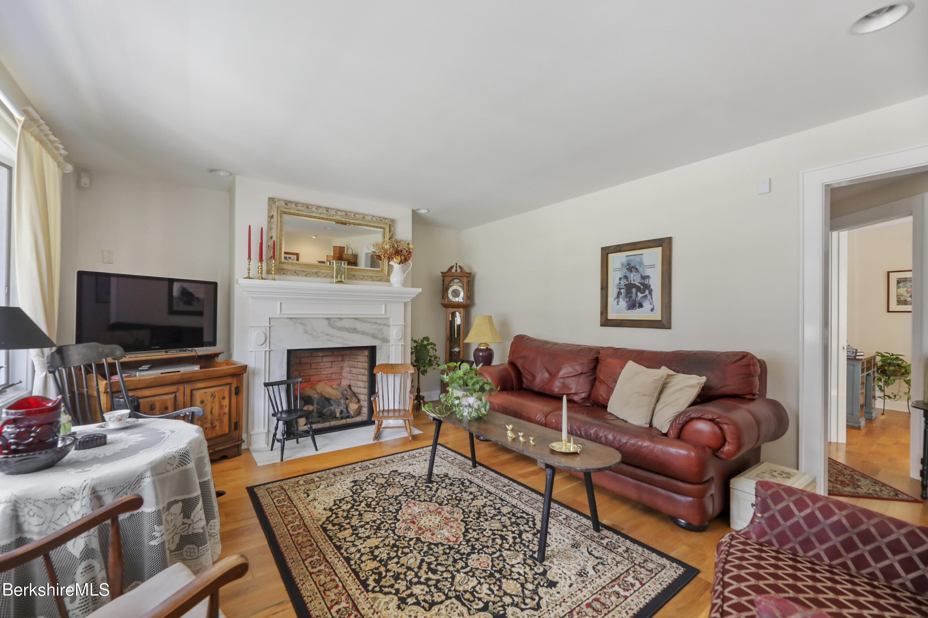 125 Center Street, Unit 2 Lee, MA 01238 - Photo 9 of 39 a living room with furniture a flat screen tv and a fireplace