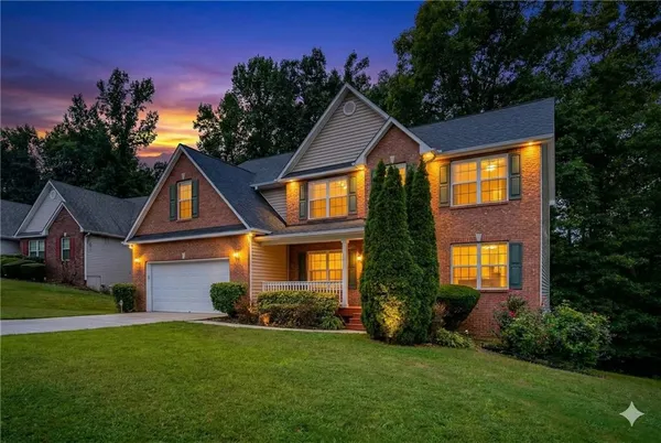 a front view of house with yard and green space
