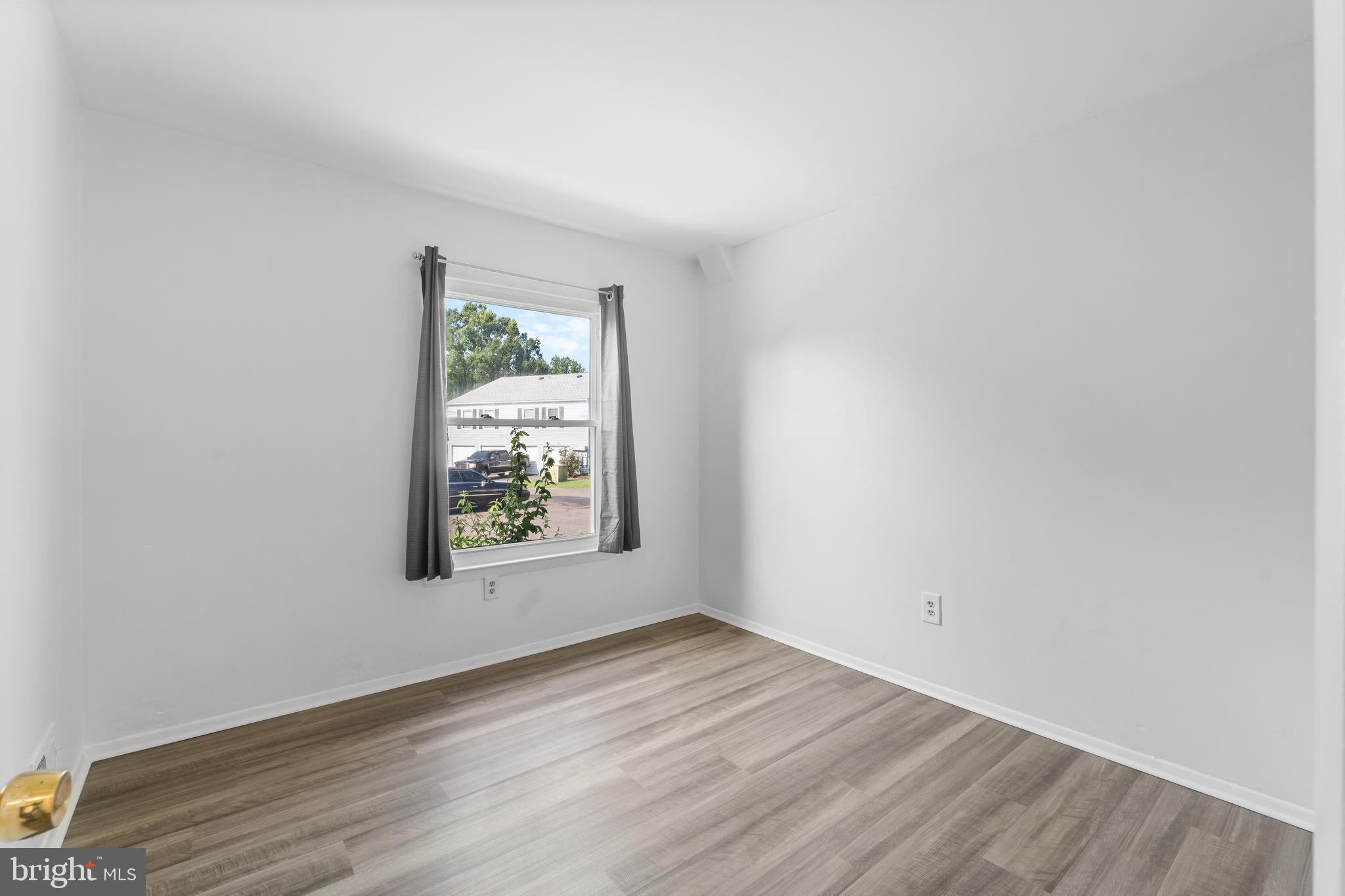 3011 Chester Grove Road, Unit A Upper Marlboro, MD 20774 - Photo 11 of 22 an empty room with wooden floor and window