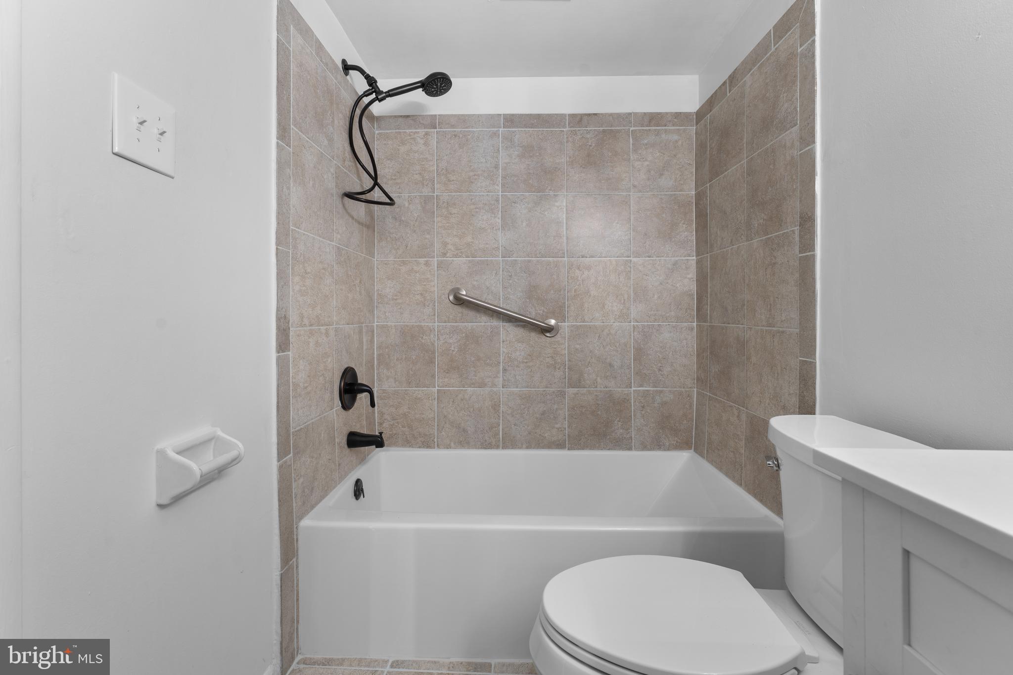 3011 Chester Grove Road, Unit A Upper Marlboro, MD 20774 - Photo 14 of 22 a bathroom with a toilet and a bath tub