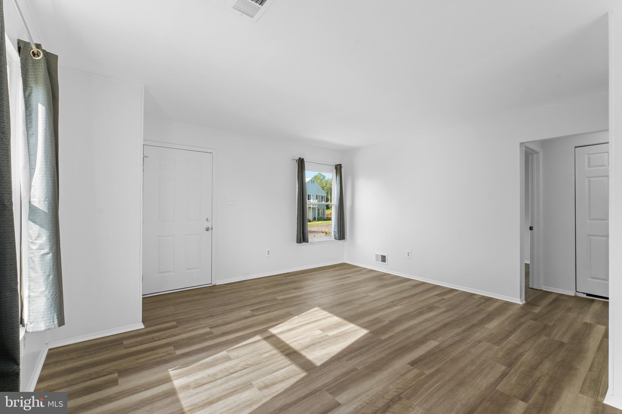 3011 Chester Grove Road, Unit A Upper Marlboro, MD 20774 - Photo 5 of 22 a view of empty room with wooden floor and fan
