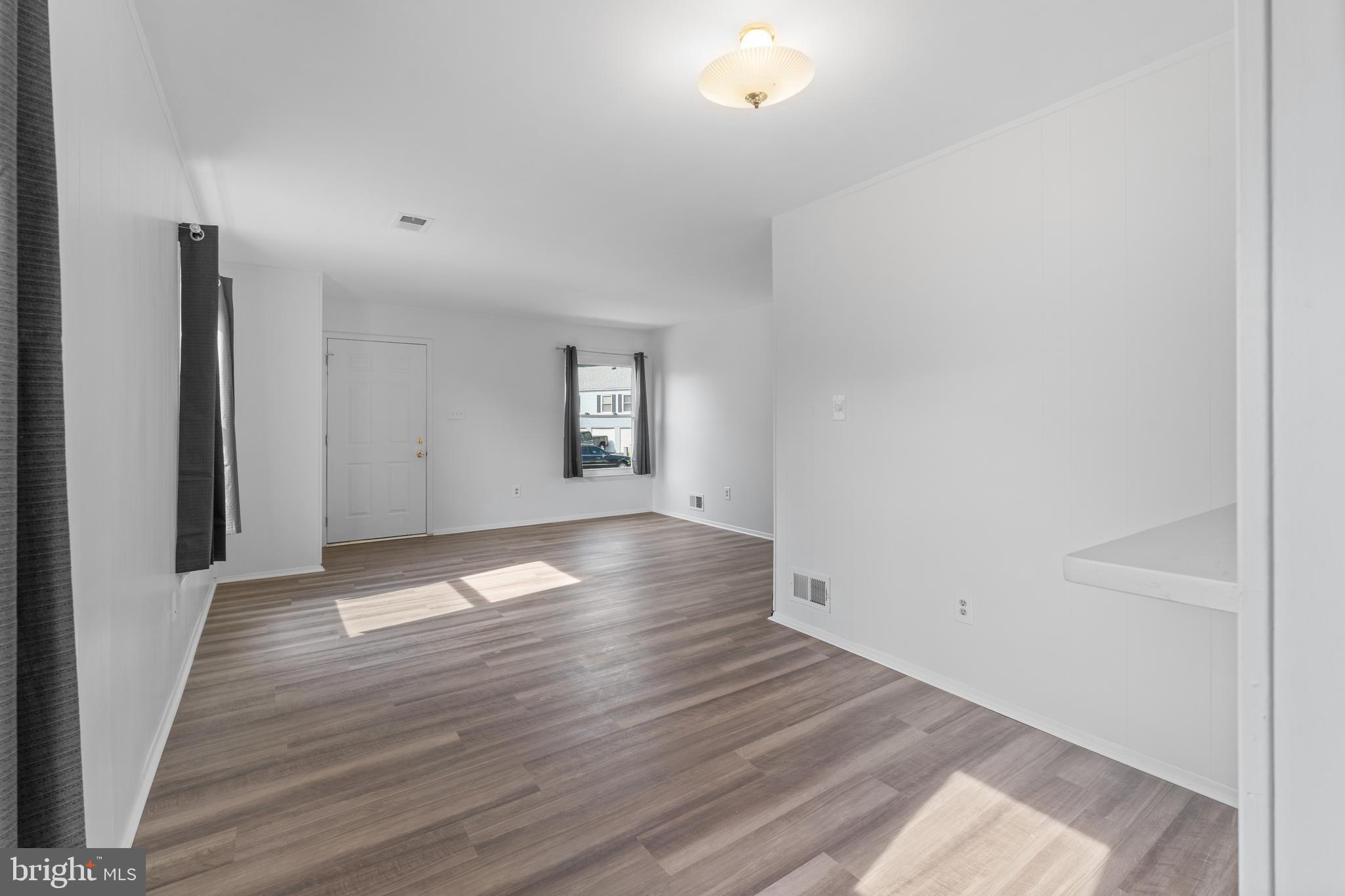 3011 Chester Grove Road, Unit A Upper Marlboro, MD 20774 - Photo 10 of 22 an empty room with wooden floor and windows
