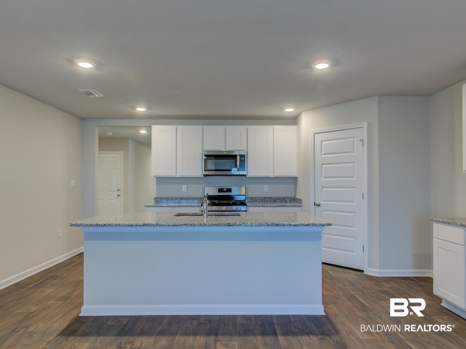 23952 Citation Loop Daphne, AL 36526 - Photo 12 of 69 Kitchen featuring white cabinets, light stone countertops, stainless steel appliances, dark wood-style floors, and recessed lighting