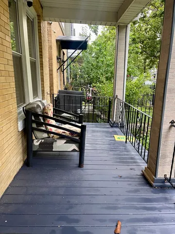 a view of a chairs and table in patio with wooden floor
