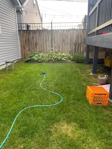 a view of a backyard with table and chairs