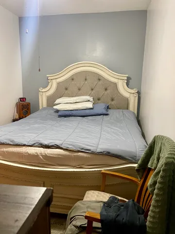 a bedroom with a bed and window