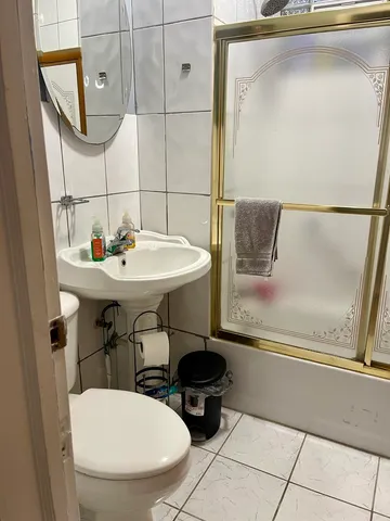 a bathroom with a sink a toilet and mirror