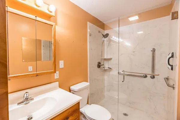 a bathroom with a sink toilet and shower