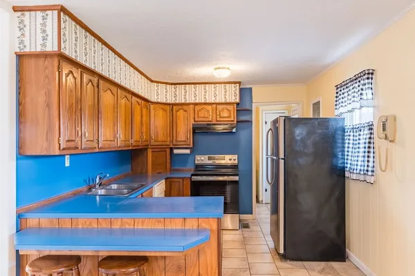 a kitchen with stainless steel appliances granite countertop a refrigerator a sink and a stove