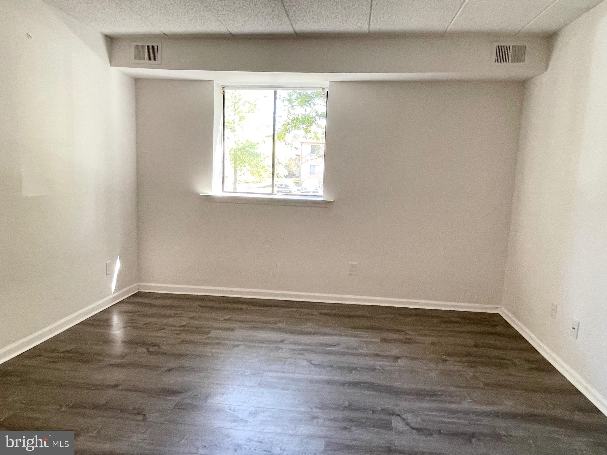 50 Le Forge Court, Unit 50 Chesterbrook, PA 19087 - Photo 13 of 17 a view of an empty room with wooden floor and a window