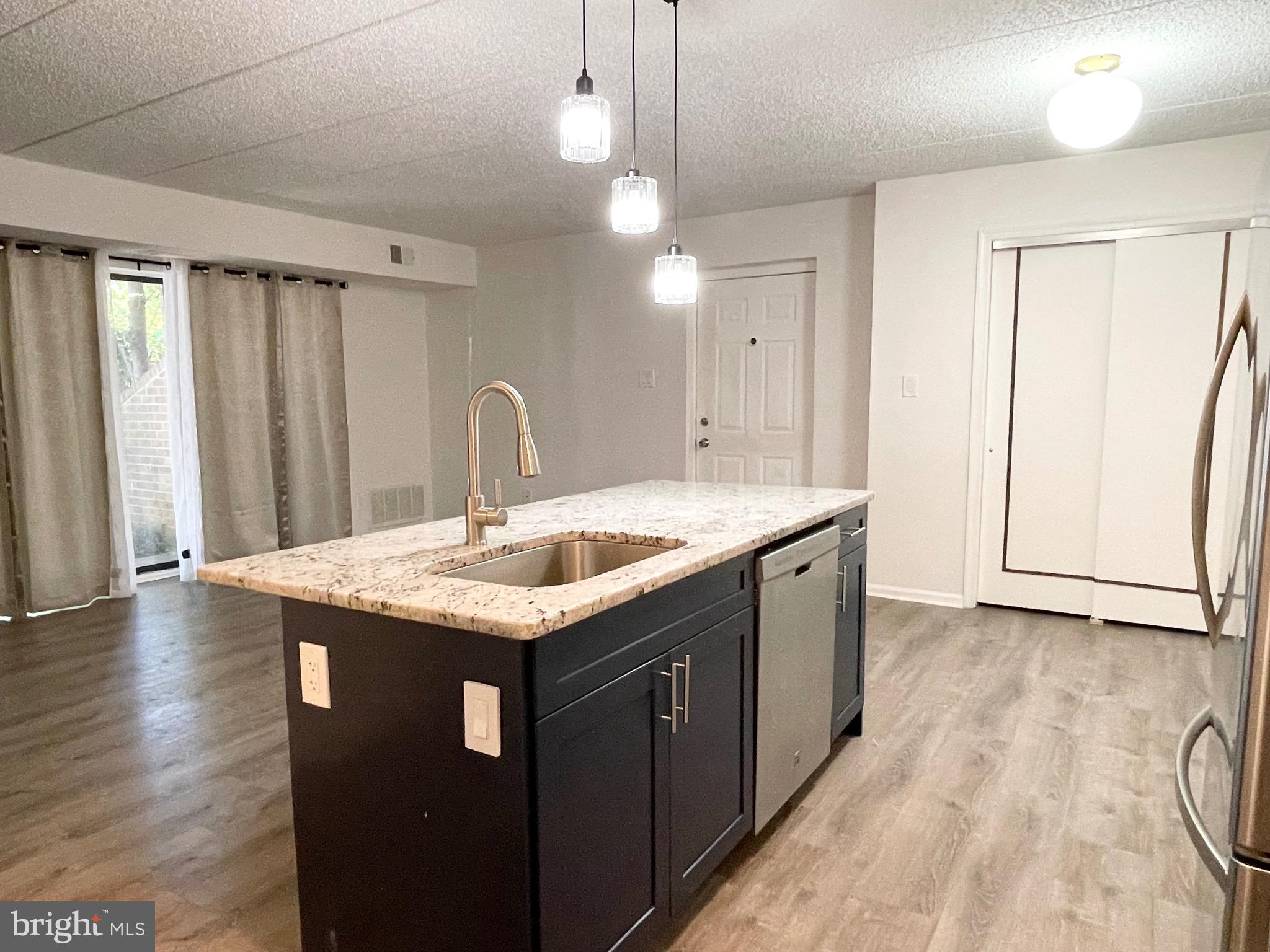 50 Le Forge Court, Unit 50 Chesterbrook, PA 19087 - Photo 16 of 17 a kitchen with a sink a counter top space and wooden floor