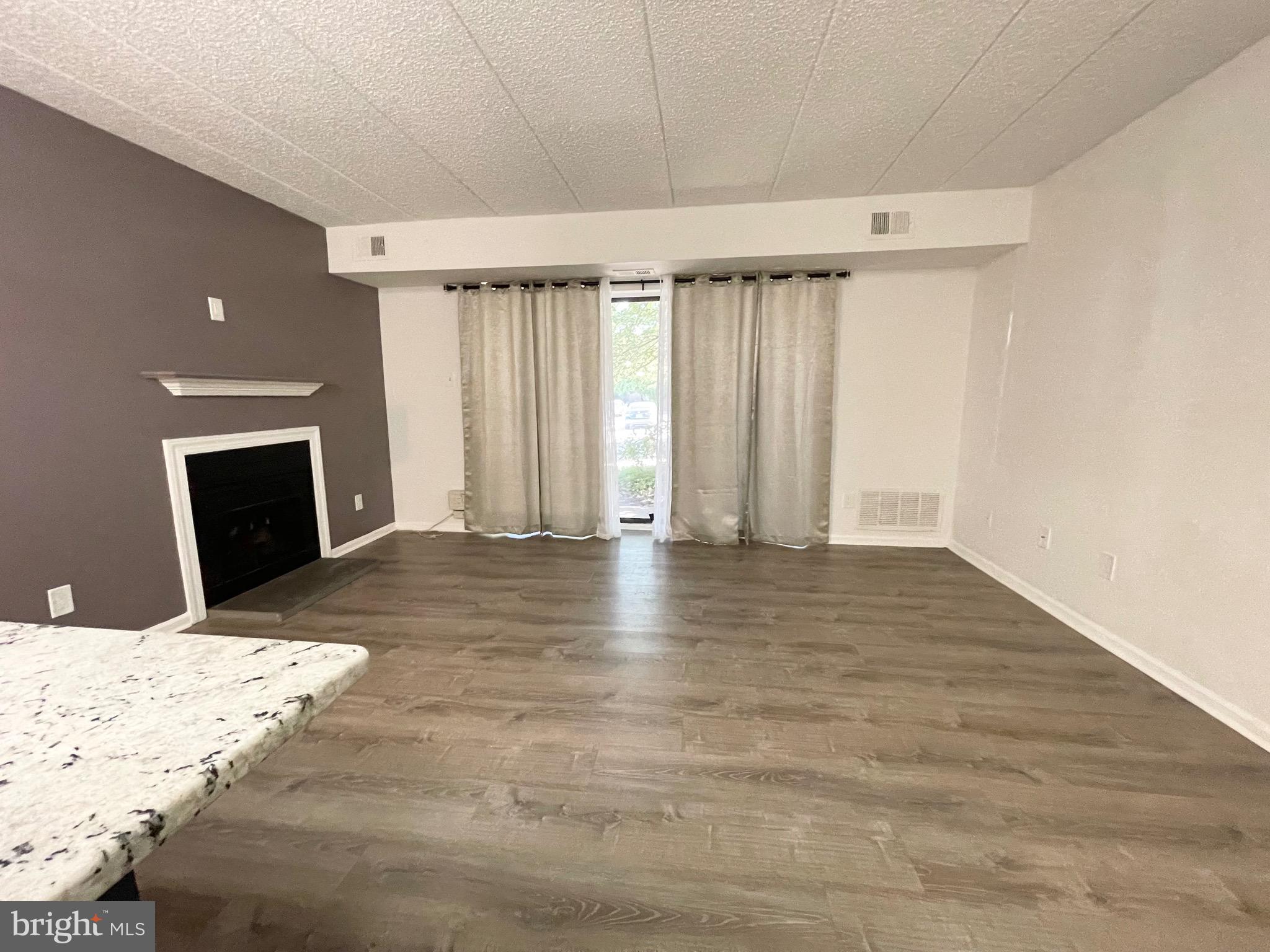 50 Le Forge Court, Unit 50 Chesterbrook, PA 19087 - Photo 3 of 17 a view of an empty room with wooden floor and a window