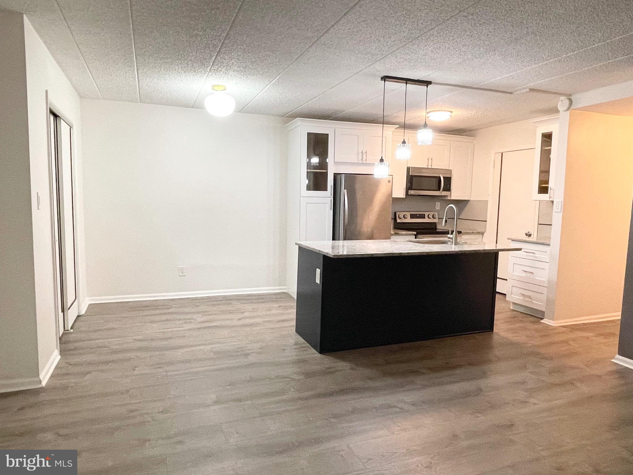 50 Le Forge Court, Unit 50 Chesterbrook, PA 19087 - Photo 5 of 17 a kitchen with kitchen island stainless steel appliances a sink and counter space