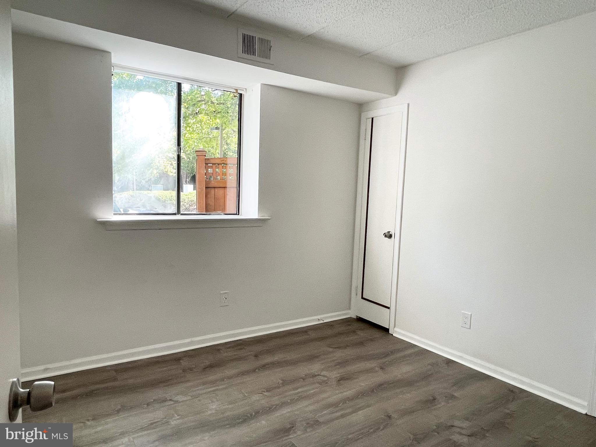 50 Le Forge Court, Unit 50 Chesterbrook, PA 19087 - Photo 9 of 17 an empty room with wooden floor and windows