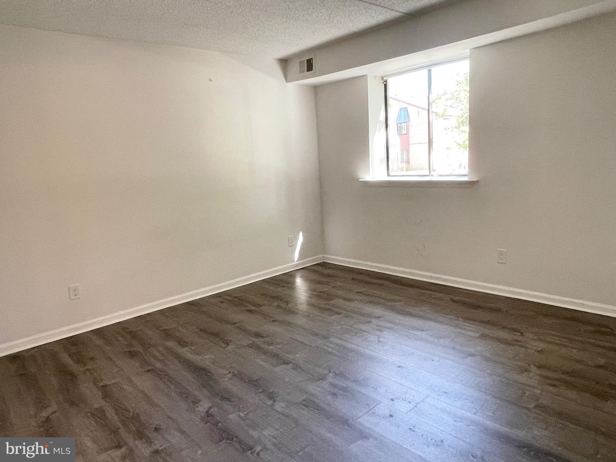 50 Le Forge Court, Unit 50 Chesterbrook, PA 19087 - Photo 10 of 17 an empty room with wooden floor and windows