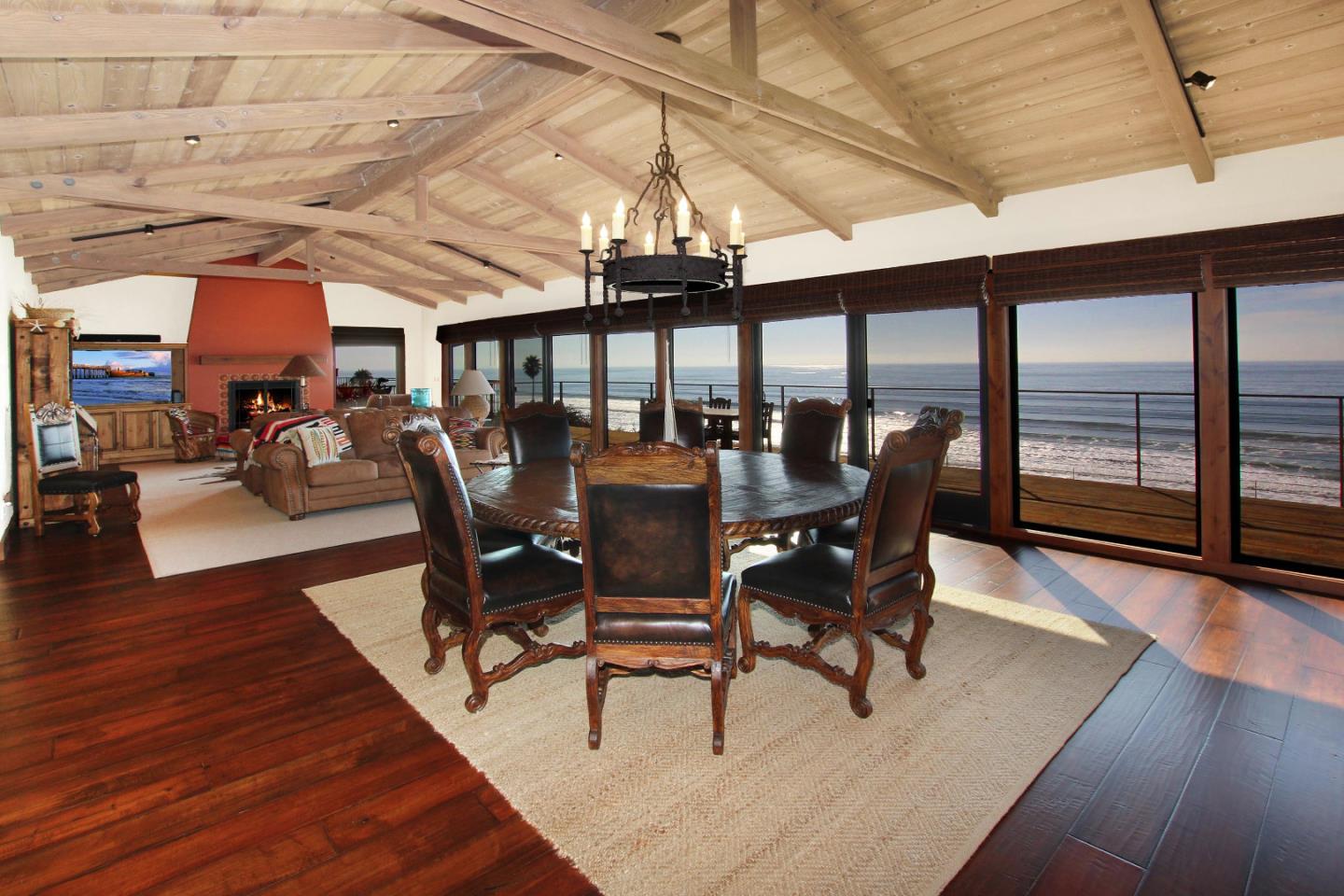 195 Vía Concha Aptos, CA 95003 - Photo 2 of 50 a dining room with wooden floor a chandelier a glass table and chairs