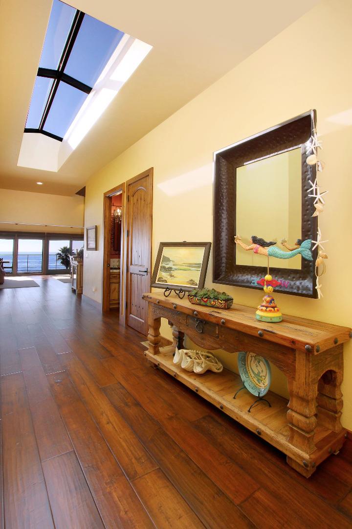 195 Vía Concha Aptos, CA 95003 - Photo 9 of 50 a living room with a table a flat screen tv and next to a window
