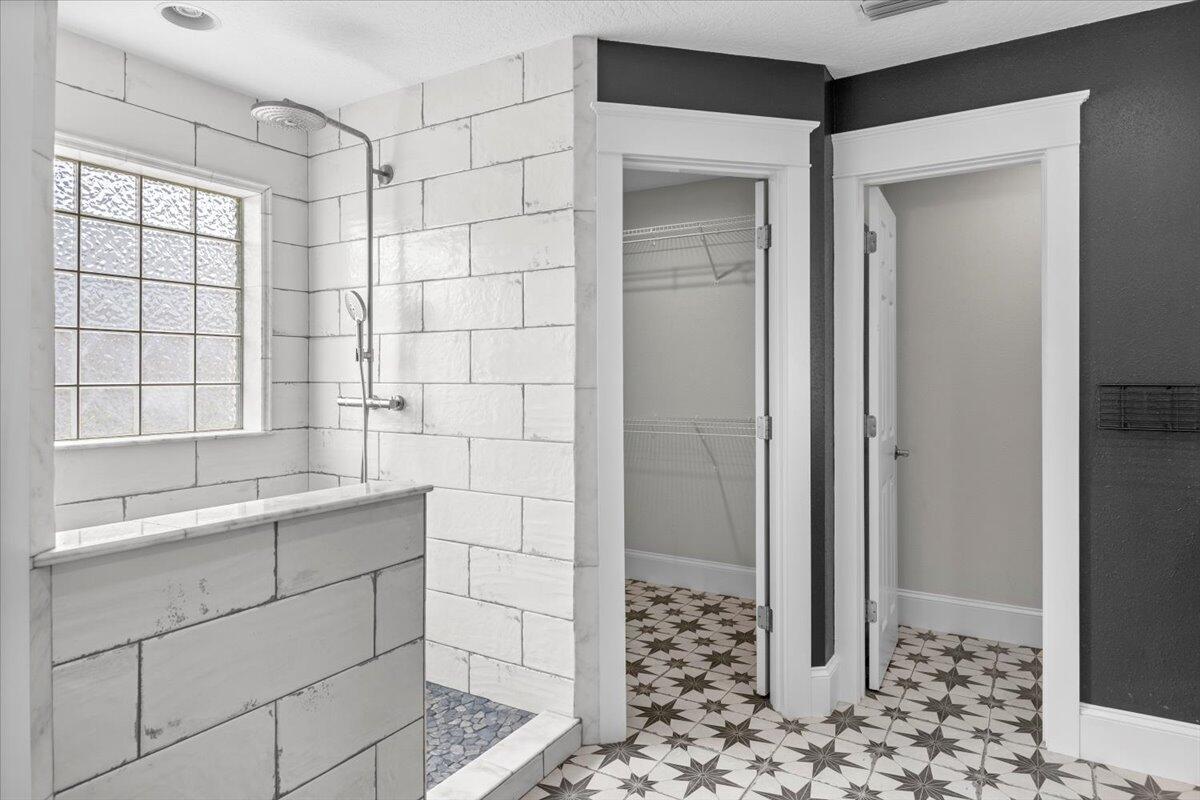 7584 Woodmont Road Navarre, FL 32566 - Photo 20 of 62 a bathroom with a shower and a sink